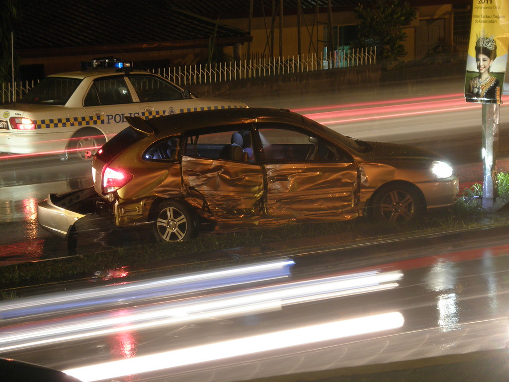 Damaged sedan after a car accident at night